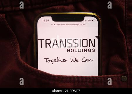 KONSKIE, POLAND - January 15, 2022: Shenzhen Transsion Holdings Co Ltd logo displayed on mobile phone hidden in jeans pocket Stock Photo