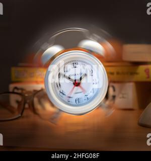 ringing alarm clock on a bedside table Stock Photo