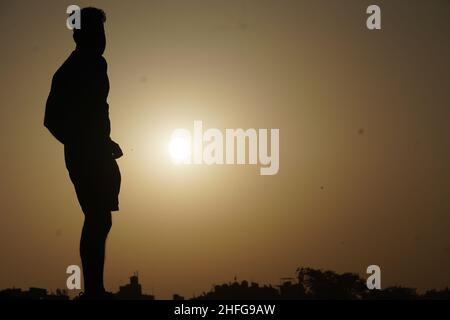silhouette image of man with sun - motivational concept Stock Photo