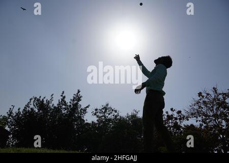 Indian man in action of catching ball in cricket match Stock Photo