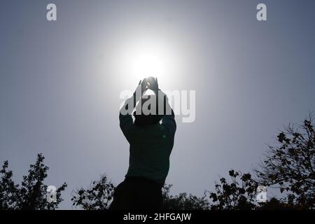 Indian bowler in action of catching ball in cricket match Stock Photo