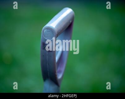 Plastic blue handle for shovels on a green background Stock Photo