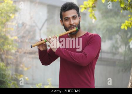 Man Playing Flute - Indian Musical Instrument Stock Photo