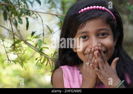 A beautiful Girl Watching in camera and smiling - Girl Education Concept Stock Photo