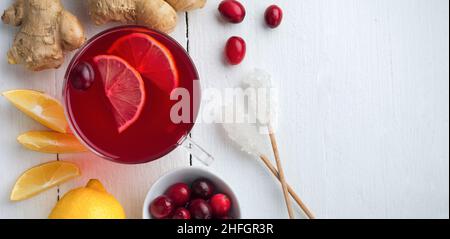 Fresh cranberry juice with lemon, berry, ginger and sugar on a light background. Top view. Space for text. Selective focus. Stock Photo
