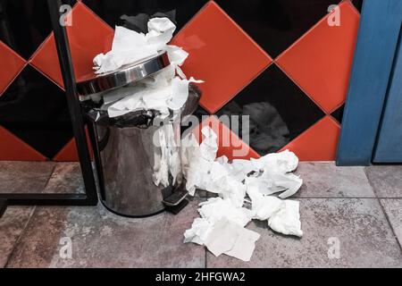 Waste paper napkins in a trash can in a public toilet. Stock Photo