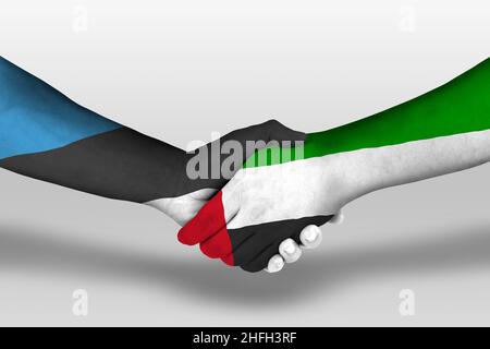 Handshake between united arab emirates and estonia flags painted on hands, illustration with clipping path. Stock Photo