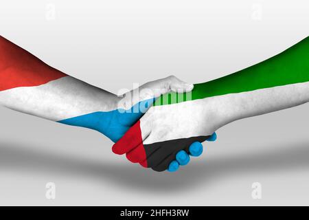 Handshake between united arab emirates and luxembourg flags painted on hands, illustration with clipping path. Stock Photo