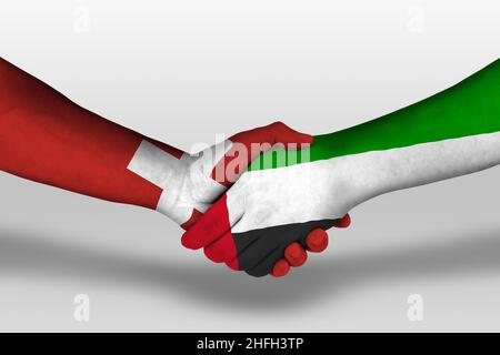 Handshake between united arab emirates and switzerland flags painted on hands, illustration with clipping path. Stock Photo