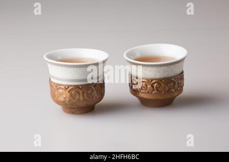 Two traditional oriental cups with freshly brewed black tea. Stock Photo