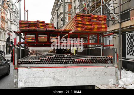 London, England - June 2020: Scaffolding poles and wooden planks being delivered to a construction site in central London. Stock Photo