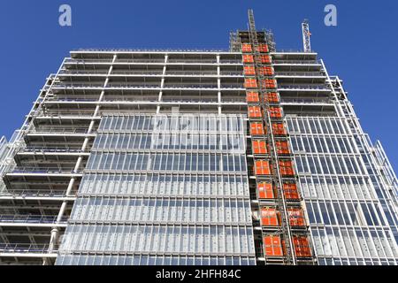 London, England - June 2020: External elevator on the side of a tall new building under construction Stock Photo