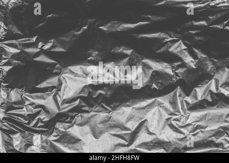 Foil crumpled texture wrinkled silver material abstract pattern surface background. Stock Photo