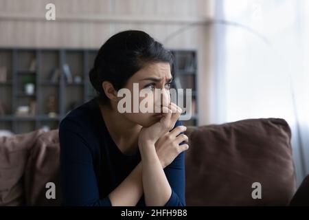 Thoughtful young Indian ethnic woman suffering from problems. Stock Photo