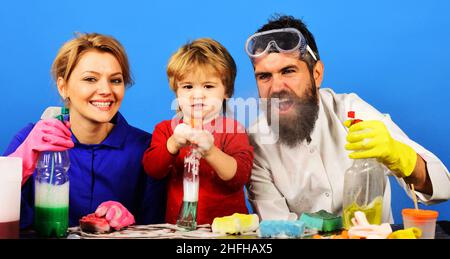 Spring cleaning. Family cleans together in house. Kid helping parent. Cute little helper with spray. Stock Photo