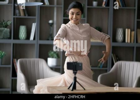 Happy young Indian woman recording video on cellphone. Stock Photo