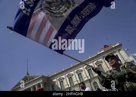 A war veteran waves flags of El Salvador and the United States during a march of war veterans and social movements to protest against the authoritarian policies of the Salvadoran government on the 30th anniversary of the signing of the peace accords.In 1992 El Salvador put an end to a 12 year war with a peace treaty signed in Mexico between the Salvadoran government and former guerrilla Frente Farabundo Martí para la Liberación Nacional (FMLN). President of El Salvador Nayib Bukele through his party in Congress voted a law to remove the anniversary as a national day. Stock Photo