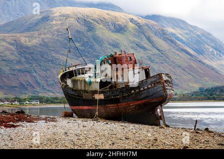 The Old fishing boat on the shingled shoreline of Loch Linnhe near Fort William , Scotland highland, UK