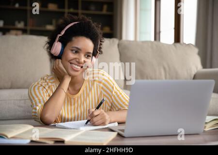 Happy young attractive African American woman studying distantly. Stock Photo