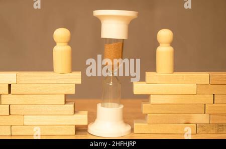 Wooden model of family, house and hourglass. Divorce and divide concept