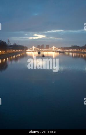 Late afternoon one winter day on Battersea bridge. wonderful sky and light above Albert bridge in London. Stock Photo