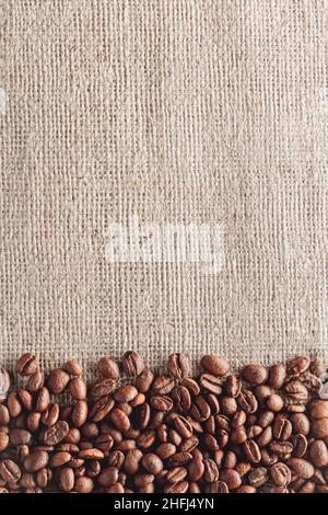 Coffee beans on burlap background Stock Photo