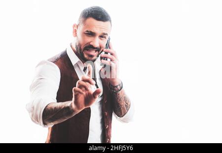 Man talking on the phone. Cheerful young handsome man talking on mobile phone. Portrait of handsome excited cheerful joyful guy wearing casual. Using Stock Photo
