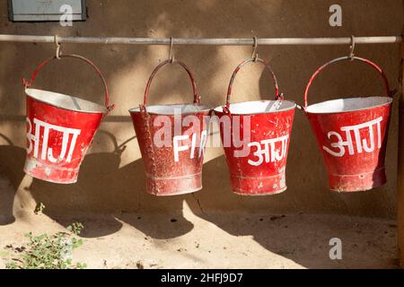 red fire buckets filled with sand  to protect in case of fire Stock Photo