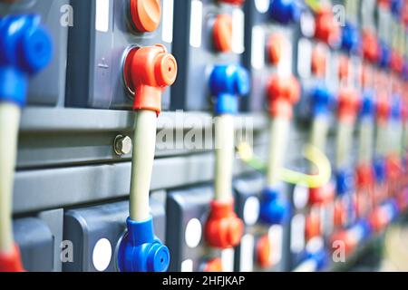 Close-up contacts on rechargeable batteries, red and blue terminal blocks. Stock Photo