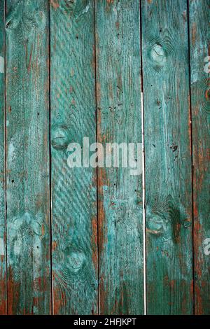 Old close boarded fence painted with sun-faded green color, textured background with space for your text. Stock Photo