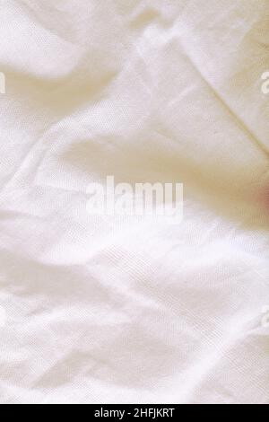 White crumpled textile as a textured background with space for your designing. Stock Photo