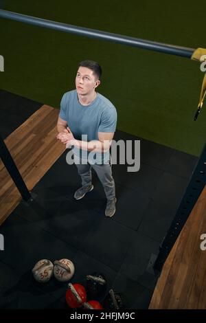 Focused young Caucasian man preparing for pull-ups Stock Photo