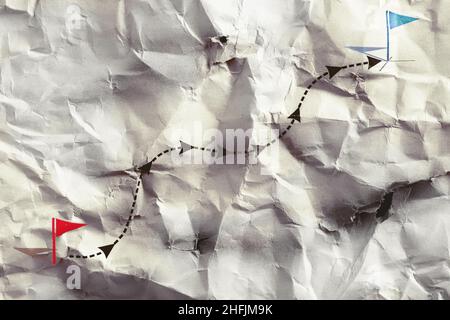 Paper with a depicted development vector, which was rushly rumpled, and then unfolded again. Stock Photo