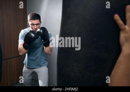 Serious focused Caucasian kickboxer preparing for workout Stock Photo