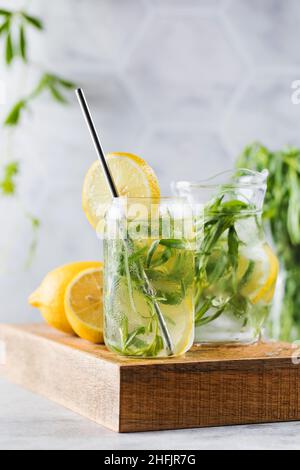 Refreshing homemade lemonade with tarragon and lemon. Summer drinks. Stock Photo