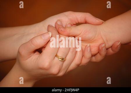 mother hand holding her child hand Stock Photo