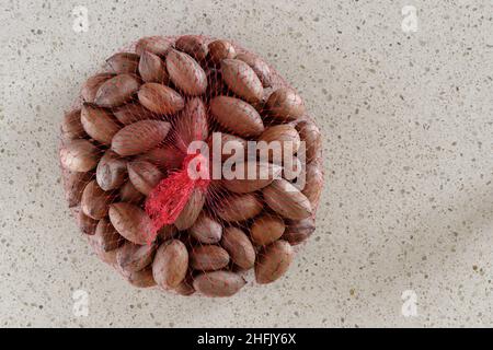 Pecan Nuts in red netting bag Stock Photo