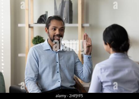 Happy diverse people practicing body language, communicating in office. Stock Photo