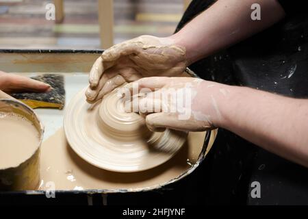 Clay modeling training on a potters wheel, clay master class. Art, creativity. Modeling clay, cultural traditions, hobby Stock Photo