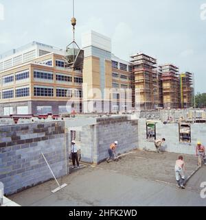Chelsea and Westminster Hospital, Fulham Road, Kensington and Chelsea, London, 01/08/1991. A view from the south east showing Chelsea and Westminster Hospital during construction, with workers levelling concrete for the ground floor of the Mental Health Centre in the foreground. Laing Management Contracting worked on the construction of Chelsea and Westminster Hospital on behalf of the North West Thames Regional Health Authority between 1989 and 1993. The new teaching hospital was built on the site of the old St Stephen&#x2019;s Hospital, which was demolished in the early months of 1989. The u Stock Photo