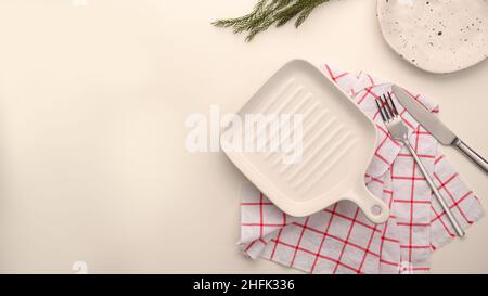 Plate mockup with silverware, empty modern minimal table place setting with minimal red kitchen towel. Space for text or menu. tableware concept, top Stock Photo