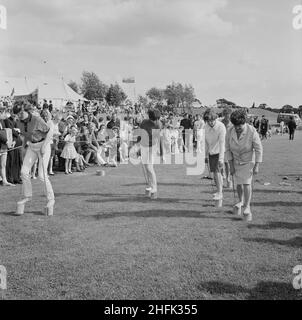 Laing Sports Ground, Rowley Lane, Elstree, Barnet, London, 26/06/1965. Women competing in a flower pot race, with spectators behind a rope fence, at the annual Laing sports day held at the Laing Sports Ground at Elstree. In 1965 Laing's annual sports day was held at the sports ground on Rowley Lane on 26th June. As well as football and athletics, there were novelty events including the sack race and Donkey Derby, and events for children including go-kart races, fancy dress competitions, and pony rides. Stock Photo