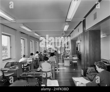 County Hall, A6352, Aykley Heads, Durham, County Durham, 24/09/1963. Office workers operating IBM 056 card verifier machines in the new County Offices at Durham. A keypunch was a device used for precisely punching holes into cards at specific locations, determined by the keys struck by a human operator. The verifier operators entered exactly the same data as the keypunch operator, and the machine then checked to see if the punched data matched. The IBM 056 machine was the verifier companion to the IBM 024 Card Punch and IBM 026 Printing Card Punch. Stock Photo