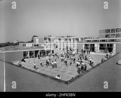 County High School, Gedling Road, Arnold, Gedling, Nottinghamshire, 11/09/1959. A view of the main courtyard at Arnold County High School filled with school children, seen from the roof of the 'houseblock' to the south-east. The school operated a house system of three houses for sports, scholastic and social activities. Rooms for housemasters, pupil dining rooms and kitchens were contained in the 'houseblock' that surrounded the central courtyard on three sides. This photograph featured in the October 1959 issue of Team Spirit, the Laing company newsletter in a story documenting the project's Stock Photo