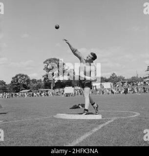 Laing Sports Ground, Rowley Lane, Elstree, Barnet, London, 26/06/1965. A man putting a shot during a shot put competition at the annual Laing sports day held at the Laing Sports Ground at Elstree. In 1965 Laing's annual sports day was held at the sports ground on Rowley Lane on 26th June. As well as football and athletics, there were novelty events including the sack race and Donkey Derby, and events for children including go-kart races, fancy dress competitions, and pony rides. Stock Photo