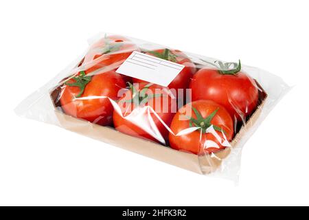 Packed and labeled fresh tomatoes on isolated white background Stock Photo