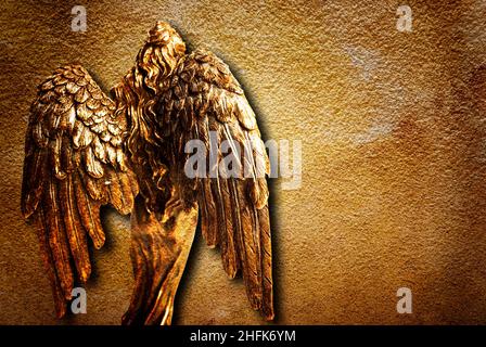 golden angel statue with big wings, from behind Stock Photo