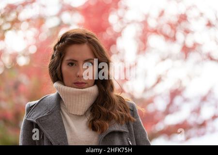 Close-up portrait of a young woman looking at camera very serious Stock Photo