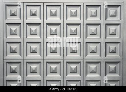 A pattern of squares on a black iron background. ornamental gate in a house. Stock Photo