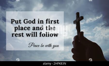 Inspirational quote of faith - Put God in first place and the rest will follow. With hand holding a Cross with sky background. Christian concept. Stock Photo